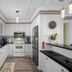 Carousel Suites Redington Shores kitchen with white cabinets, black countertops, stainless appliances and window seat