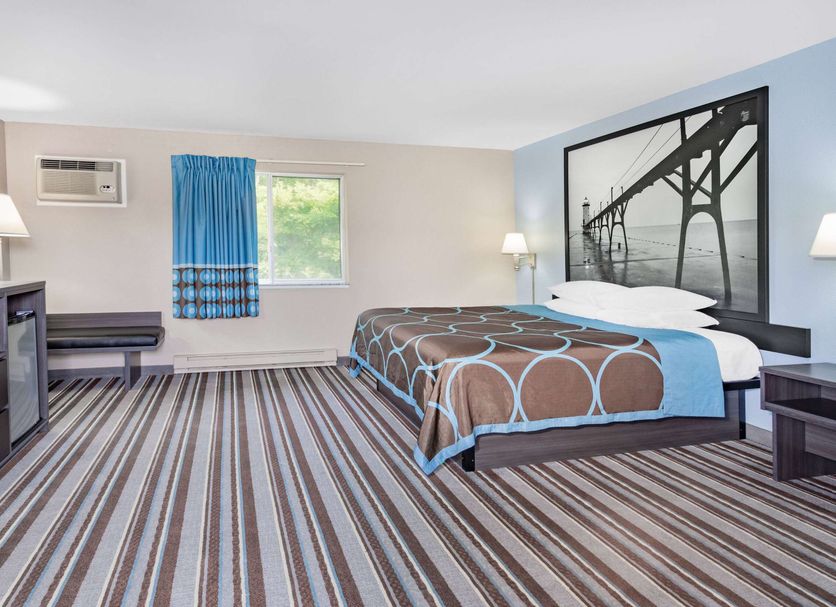 Super 8 by Wyndham Marysville/Port Huron Area guest room with bed and bridge wall art