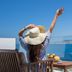 Porto Kaza in Sitia, woman relaxing on a balcony with sea view and fruit on a table