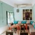Riad Dar Ayur Marrakech lounge with L-shaped sofa, turquoise cushions, and wooden tables