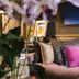 B&B The Verhaegen Ghent lounge with plush sofa, colorful pillows, and floral decor