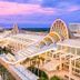 Holiday Inn Orlando-Disney Springs Area By IHG in Lake Buena Vista, exterior with arched roof and palm-lined walkway