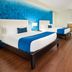 Ramada Plaza Panama Punta Pacifica guest room in Panama City with two beds and seating area