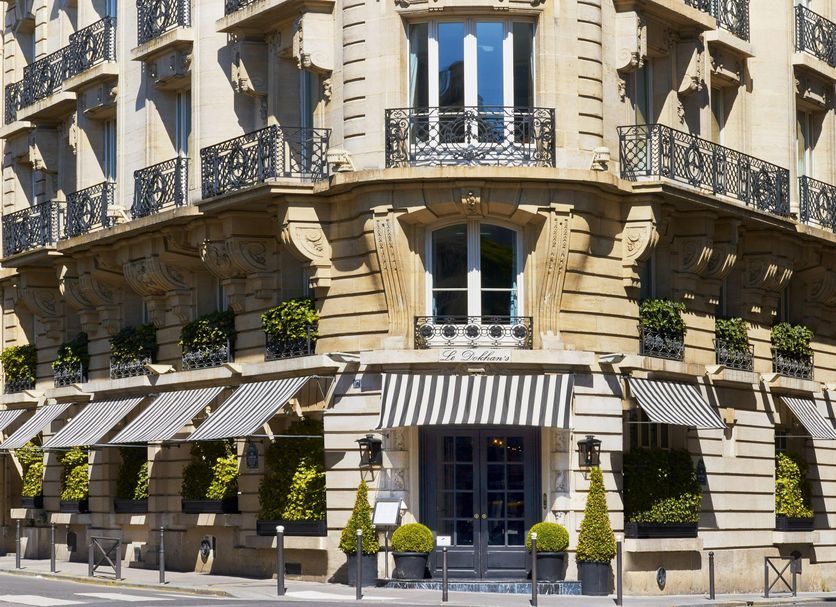 Le Dokhan's, Paris Arc de Tiromphe, a Tribute Portfolio Hotel exterior with striped awnings and corner balconies in Paris