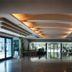 Hotel Bavaria Blu lobby in Mamaia with glass doors, seating area, and illuminated ceiling panels