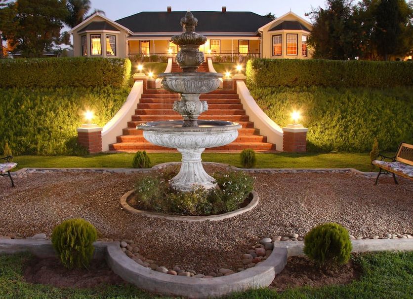 La Plume Boutique Hotel & Spa in Oudtshoorn: evening view of fountain and lit front steps