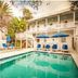 Casa 325 in Key West with outdoor pool, blue lounge chairs, and palm trees
