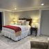 The Inn at Cedar Grove in Vicksburg, a cozy guest room with a bed, lamps, and marble-tile floor.