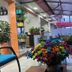 Hotel Casa Lamay Bogotá lobby with colorful flower arrangement, white sofa, and covered glass seating area