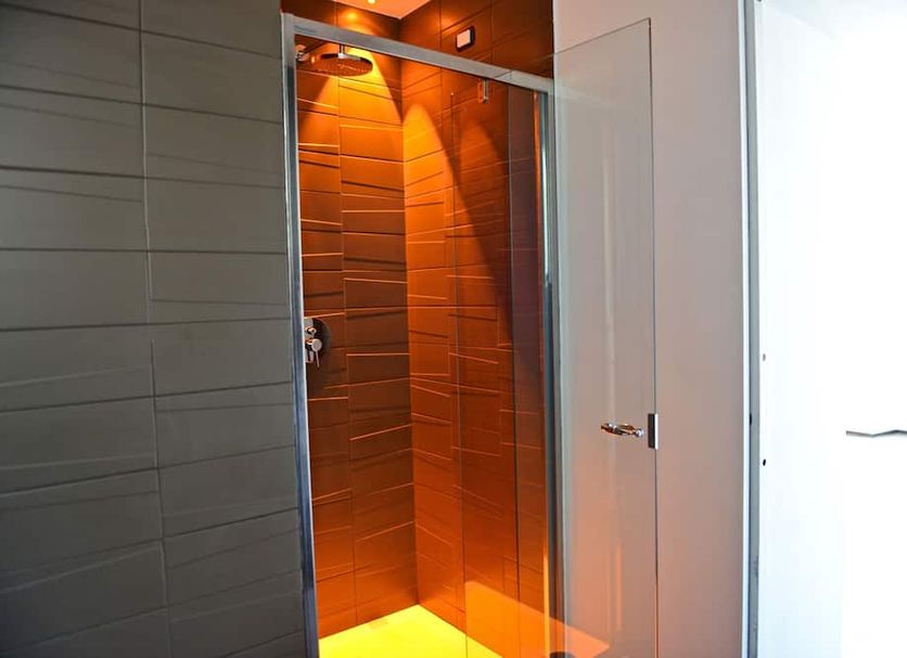 Palais La Nasse San Remo bathroom shower with orange tiled walk-in stall
