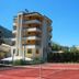 Europa Stabia Hotel in Castellammare di Stabia with tennis court and multi-story balconies under blue sky