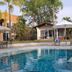 Hotel Villa Cantabria in Mascota with a swimming pool, lounge chairs and umbrellas by guest cottages