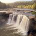 Cumberland Falls State Resort Park near Corbin featuring a scenic waterfall and forested river gorge