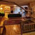 Anitya Cave House in Ürgüp cave-style room with wooden floor, seating area, and bed alcove