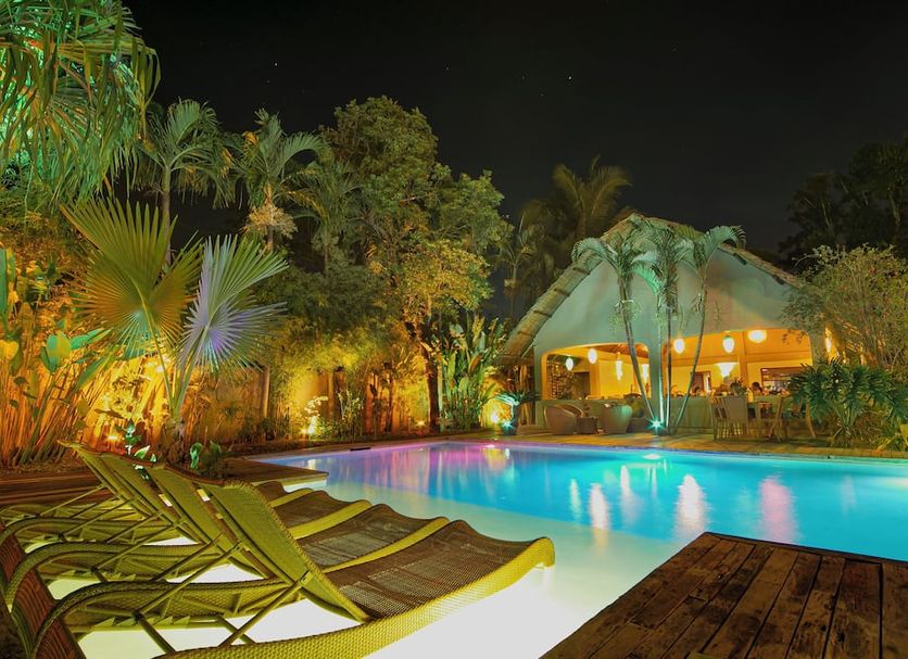Hibiscus Garden Resort in Puerto Princesa with a lit outdoor pool and tropical garden at night