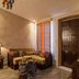 La Maison Ottomane in Chania interior lounge with corner sofa, wooden door and decorative table