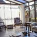 Hotel Le Renard - Campos do Jordao lounge with glass walls, sofa, chairs and garden view in Campos do Jordão