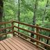 Lakeside Motel in Wisconsin Dells with a wooden deck overlooking lush forest trees