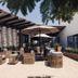 Medano Hotel and Spa in Cabo San Lucas patio with wicker seating and umbrellas