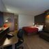 N Hôtel Québec guest room in Québec City with bed, sofa, desk and modern wood-paneled wall