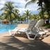 Gem Beach Resort in Kuala Terengganu with poolside loungers beside a tropical beachfront pool