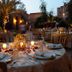 La Maison des Oliviers in Marrakech: candlelit outdoor dining tables in a courtyard garden