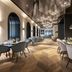 Europäischer Hof in Baden-Baden dining room with arched windows, chandeliers, and set tables