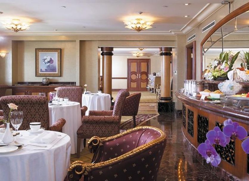 Grand Hi Lai Hotel, Kaohsiung City dining room with set tables, buffet counter, and purple orchids
