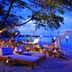 The Sarojin, Takua Pa: beachfront candlelit lounge with daybeds and ocean view at dusk