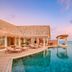 Milaidhoo Maldives in Kamadhoo, infinity pool beside overwater villas at sunset