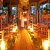 Lake Placid Lodge wedding ceremony in candlelit pavilion with chandelier and wooden aisle