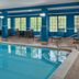 Hampton Inn Kansas City The Legends indoor pool with lounge chairs and large windows in Kansas City