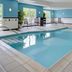 Fairfield Inn & Suites by Marriott Seymour indoor pool with seating and large windows