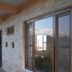 Tushita Nepal Yoga Retreat Center in Pokhara, stone exterior with large sliding glass door and mountain view