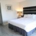 Doolan's Shore Club in Spring Lake Heights bedroom with king bed, black headboard, and bedside lamp