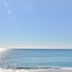 Hotel Noto Marina Vista Mare in Noto with a calm sea view and people walking along the beach