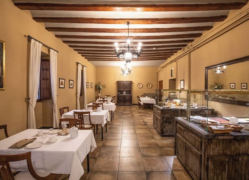 Hospederia Seminario Conciliar de San Julián dining room in Cuenca with set tables and buffet