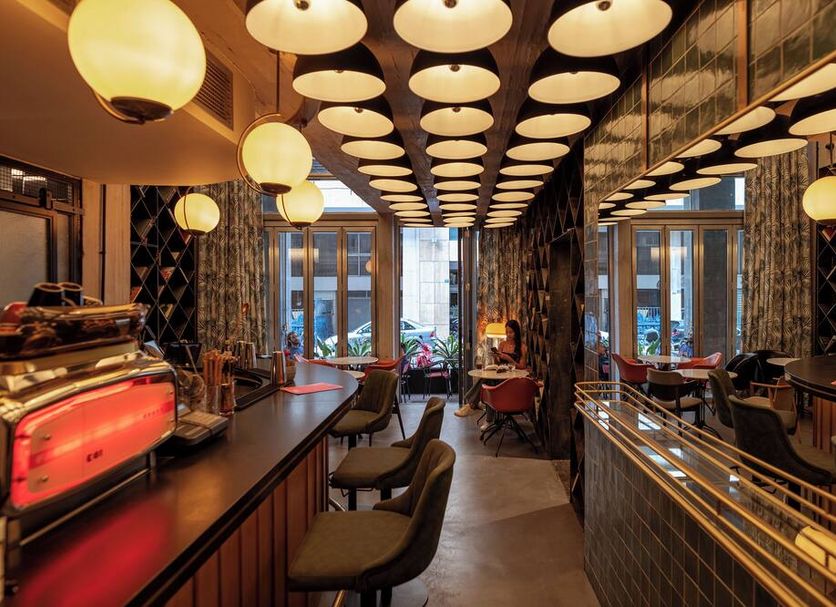 Max Brown Downtown Athens bar interior with warm pendant lights, mirrored walls, and seating