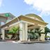 Holiday Inn Express & Suites Florida City-Gateway To Keys By IHG entrance with palm trees in Florida City
