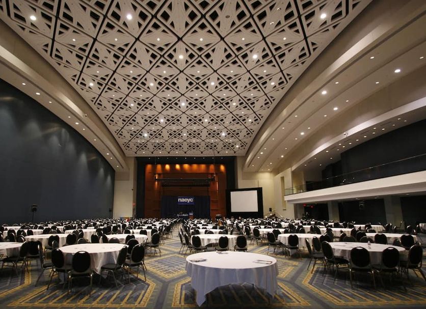 American Guest House Washington, D.C. ballroom with round banquet tables and ornate patterned ceiling