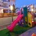 Kronos Hotel in Platamon with colorful children’s playground beside the outdoor area
