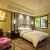 Wentou Oceanic Hotel Quanzhou guest room with king bed, seating area, and bathroom window