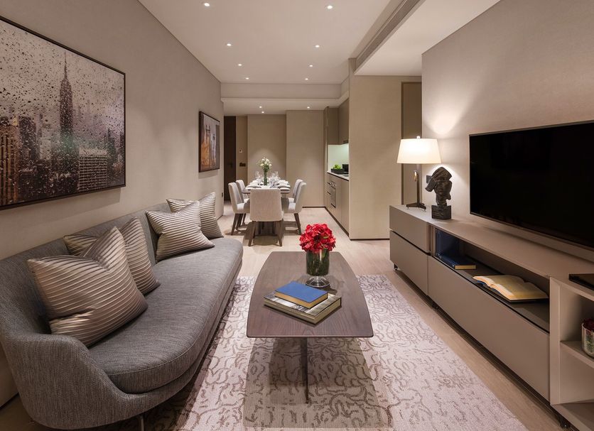 Dao By Dorsett AMTD Singapore living area with sofa, TV, dining table, and city artwork