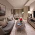 Dao By Dorsett AMTD Singapore living area with sofa, TV, dining table, and city artwork