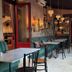 Hotel Mika Downtown Budapest lounge with tables, teal seating, and hanging pendant lights