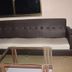Hotel cloud 9 in Madhubani room with dark sofa, glass coffee table and window