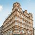 Victory House London hotel exterior with historic stone facade and corner street-level terrace in London