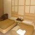 Hotel Sree Murugan in Coimbatore: twin beds with bedside tables and a wall-mounted headboard panel