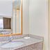 Super 8 by Wyndham Jacksonville Orange Park bathroom vanity with sink beside a tub and shower combo in Jacksonville