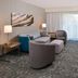 Courtyard by Marriott Charlotte Gastonia guest suite with sofa seating, TV, desk and large window